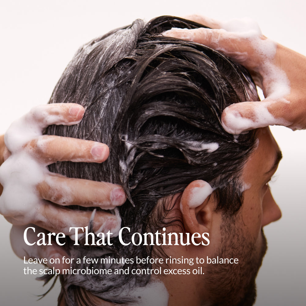 Man lathering Kerativ Redensify Reset Shampoo into his hair with text about use
