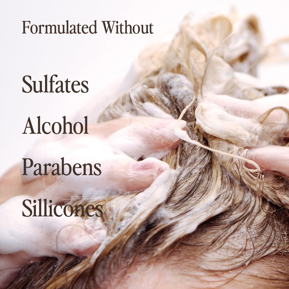 Close-up of Kerativ Redensify Reset Shampoo lathered into hair with texts of unincluded ingredients